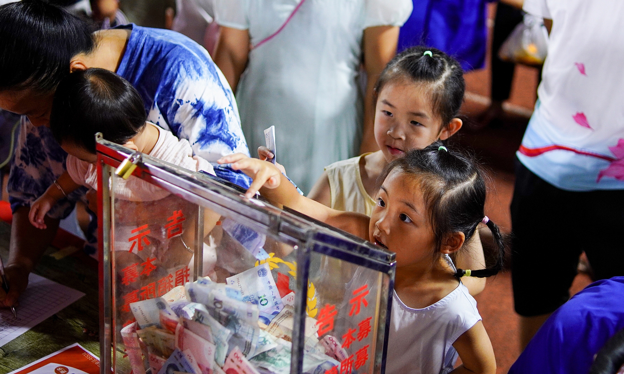 People donate money to flood-hit areas in Guangxi at the Village Super League football stadium in Rongjiang county, Southwest China's Guizhou Province, on July 8, 2026. Photo: IC