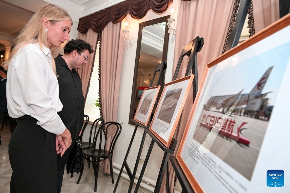 People visit a photo exhibition showcasing the achievements of Chinese modernization in Chelyabinsk, Russia, July 15, 2026. A photo exhibition showcasing the achievements of Chinese modernization opened Wednesday in Russia's central city of Chelyabinsk, attracting more than 100 participants from political, media and business circles, as well as youth representatives from China and Russia.(Xinhua/Feng Kaihua)