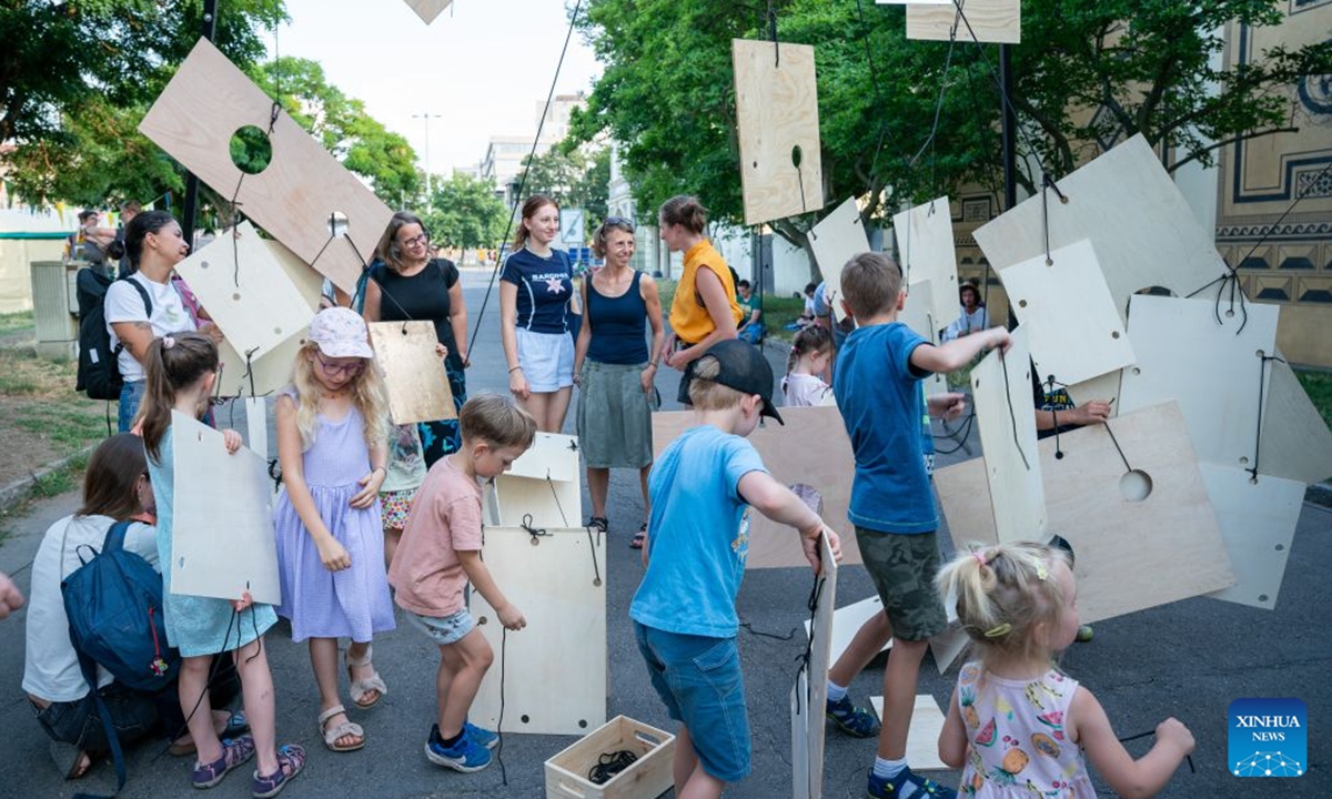 Children take part in a workshop during the street theater festival Behind the Door in Prague, the Czech Republic, July 16, 2026. The Prague street theater festival Behind the Door is held here from July 14 to 19, bringing together street theater, contemporary circus, music, acrobatics and other performances from multiple countries. (Photo by Dana Kesnerova/Xinhua)