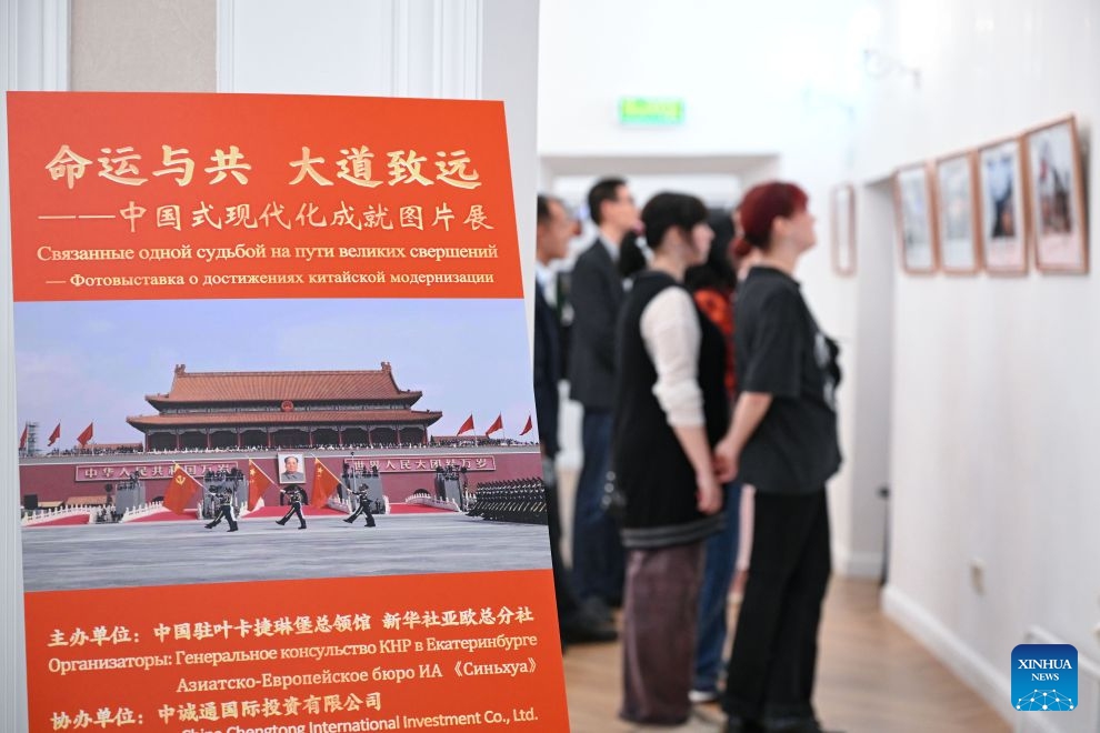 People visit a photo exhibition showcasing the achievements of Chinese modernization in Chelyabinsk, Russia, July 15, 2026. A photo exhibition showcasing the achievements of Chinese modernization opened Wednesday in Russia's central city of Chelyabinsk, attracting more than 100 participants from political, media and business circles, as well as youth representatives from China and Russia.(Xinhua/Feng Kaihua)