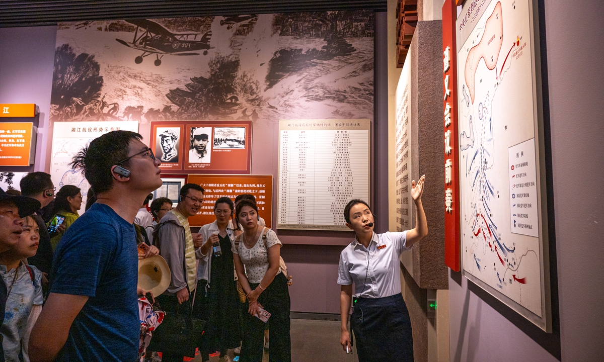 A guide explains revolutionary history to visitors at the Zunyi Conference Memorial in Guizhou Province on July 17, 2026. Photo: VCG