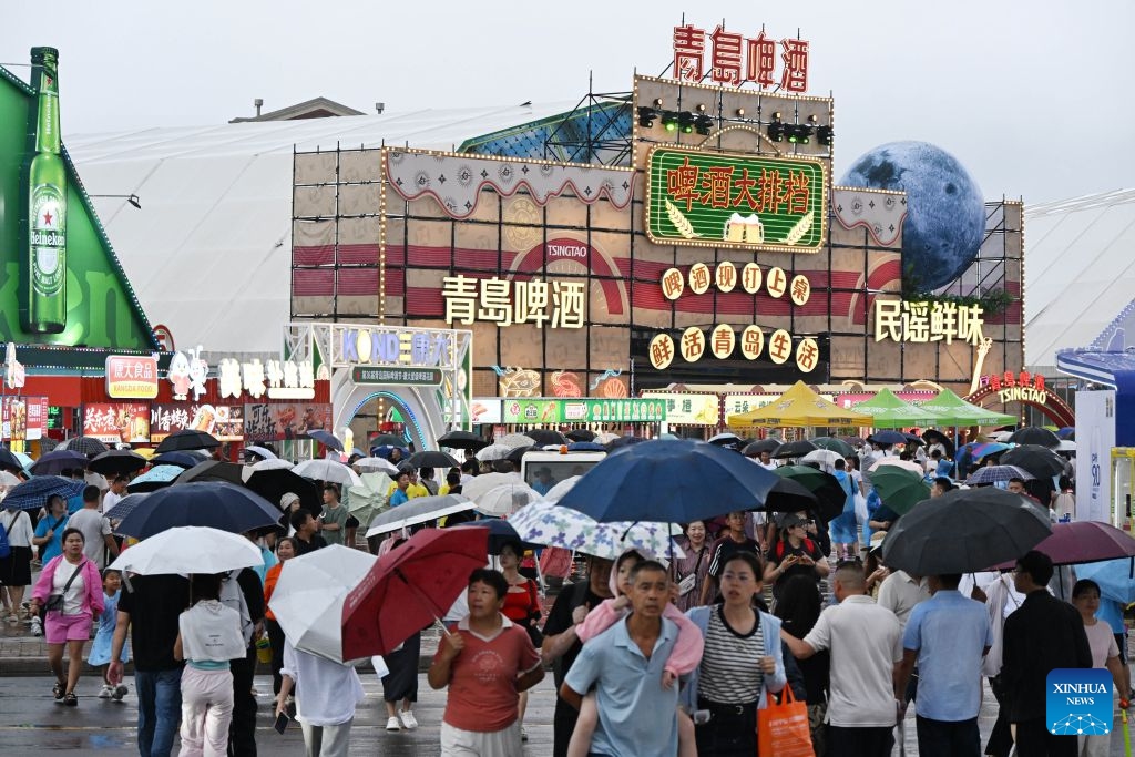 People attend the 36th Qingdao International Beer Festival at Xihai'an (West Coast) New Area in Qingdao, east China's Shandong Province, on July 17, 2026. The 36th Qingdao International Beer Festival opened on Friday evening in the coastal city of Qingdao, east China's Shandong Province, kicking off a 30-day celebration that blends brewing tradition with tech advances and cultural performances. Running until Aug. 15, the festival boasts nine beer tents offering more than 2,300 varieties from around the world, including premium craft brews and fruit-flavored beers. (Photo: Xinhu)