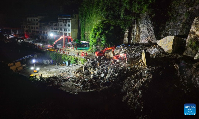 An aerial drone photo taken on July 18, 2026 shows rescuers working at the site of a landslide in Pengshui Miao and Tujia Autonomous County, southwest China's Chongqing Municipality. The geological disaster occurred at 9:08 a.m. on Friday in the Hanjia sub-district of Pengshui Miao and Tujia Autonomous County in Chongqing, burying more than 10 residential buildings. Search and rescue operations are still underway. (Xinhua/Huang Wei)