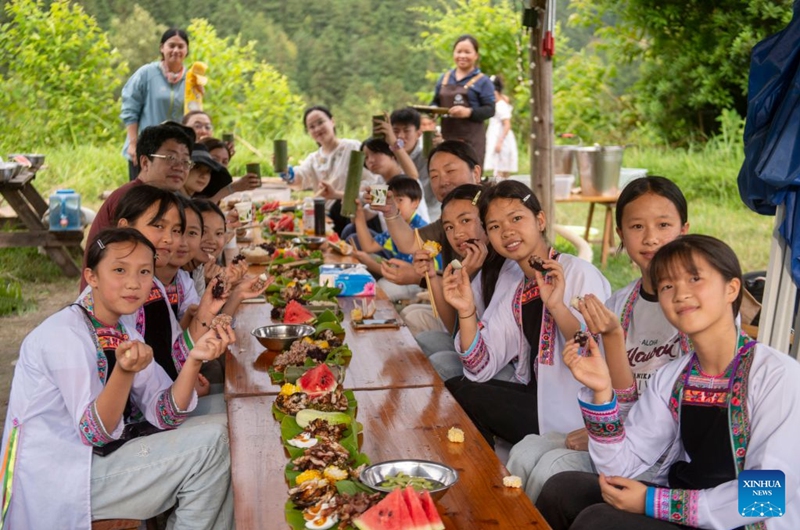 Children from Shanghai have a picnic with local friends in Meide Village of Congjiang County, Qiandongnan Miao and Dong Autonomous Prefecture, southwest China's Guizhou Province, July 15, 2026. In the summer vacation, a surging number of students from big cities like Shanghai and Shenzhen come to Meide Village of Qiandongnan Miao and Dong Autonomous Prefecture for a study tour, living with local people and experiencing the culture and customs of the Dong ethnic group. Photo: Xinhua