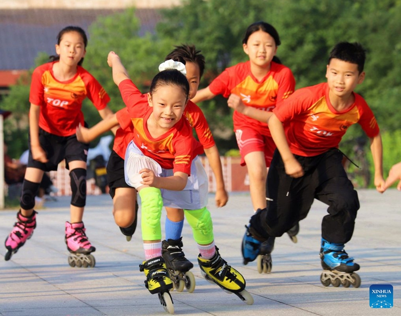 Children practise roller skating at a park in Nanyang City, central China's Henan Province, July 18, 2026. (Photo by Gao Song/Xinhua)