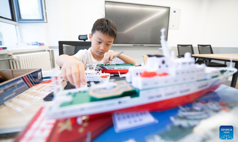 A child assembles ship models at a youth palace in Harbin, northeast China's Heilongjiang Province, July 17, 2026. (Photo by Zhang Chunlei/Xinhua)