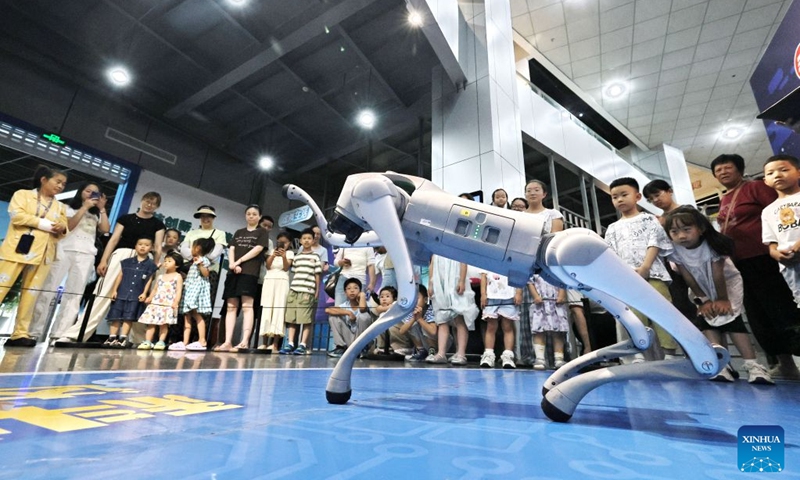 Children watch a robot dog performance with their parents at a science and technology museum in Jiaxing City, east China's Zhejiang Province, July 18, 2026. (Photo by Jin Peng/Xinhua)