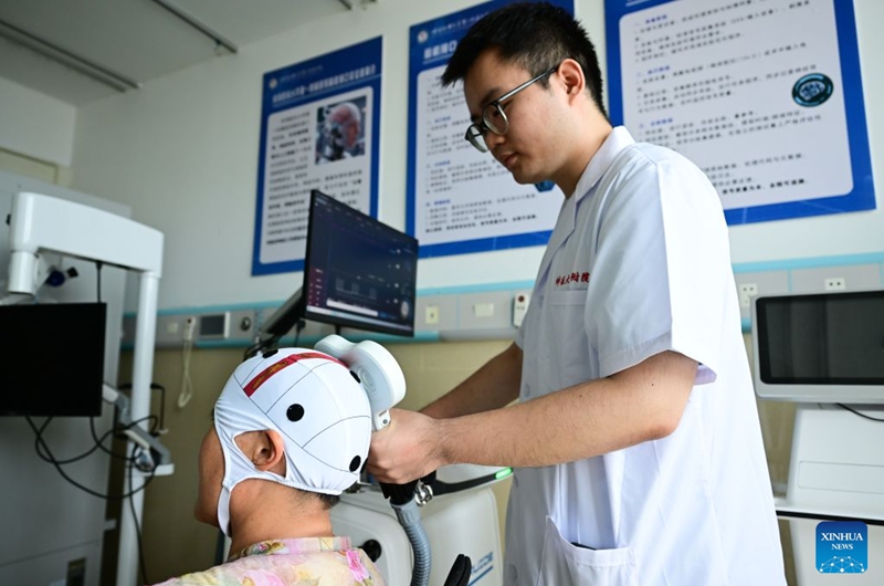 A medical worker provides rehabilitation therapy for a patient with a neuromodulation device at a hospital in Bengbu, east China's Anhui Province, July 17, 2026. Bengbu, a traditional industrial city, has stepped up the development of its brain-computer interface (BCI) industry in recent years. By strengthening collaboration among industry, research institutes and medical institutions, Bengbu has built an innovation ecosystem that supports both BCI research and clinical application, aiming to become an emerging BCI innovation hub in the Yangtze River Delta region. Photo: Xinhua