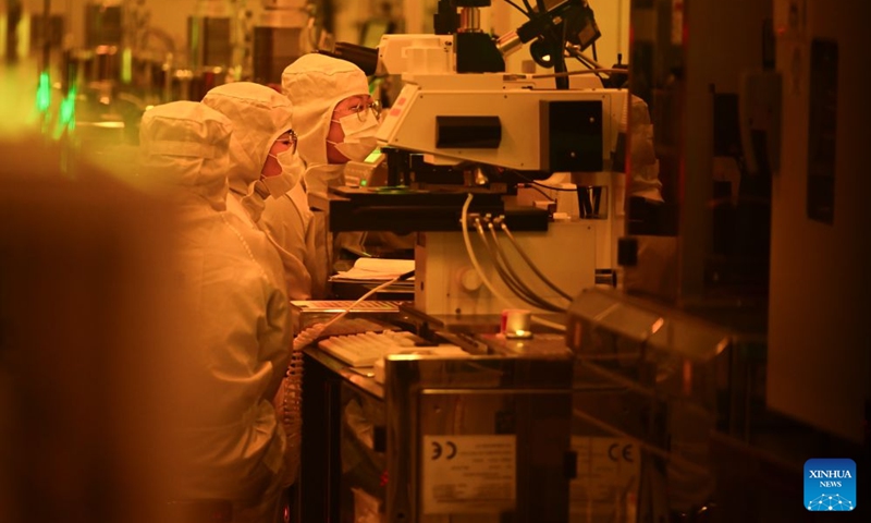 This photo taken on July 17, 2026 shows staff members working on a micro and nanofabrication production line at Anhui North Microelectronics Research Institute Group Co., Ltd. in Bengbu, east China's Anhui Province. Bengbu, a traditional industrial city, has stepped up the development of its brain-computer interface (BCI) industry in recent years. By strengthening collaboration among industry, research institutes and medical institutions, Bengbu has built an innovation ecosystem that supports both BCI research and clinical application, aiming to become an emerging BCI innovation hub in the Yangtze River Delta region. Photo: Xinhua