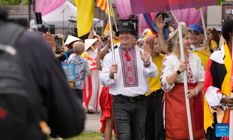 Participants in traditional costumes march during the Parade of Cultures at the Fusion Festival in Surrey, British Columbia, Canada, July 18, 2026. The two-day festival, which opened here on Saturday, featured over 50 cultural pavilions offering food, music, dance, and cultural performances from around the world. (Photo by Liang Sen/Xinhua)