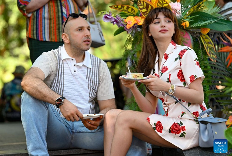 Visitors enjoy delicacies during a festival of Latin American and Caribbean culture at Hermitage Garden in Moscow, Russia, July 18, 2026. Featuring live music, performance and traditional cuisines, the festival kicked off here on Saturday and will run until July 26. (Xinhua/Feng Kaihua)