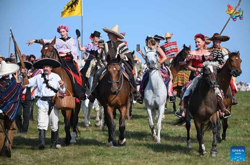 People in costumes ride horses during the Grunwald Days festival in Grunwald, Poland, on July 17, 2026. The annual Grunwald Days festival commemorates the Battle of Grunwald in 1410, which is regarded as one of the most important battles in Polish history. The festival runs from Wednesday through Sunday this year. (Photo by Alexey Vitvitsky/Xinhua)