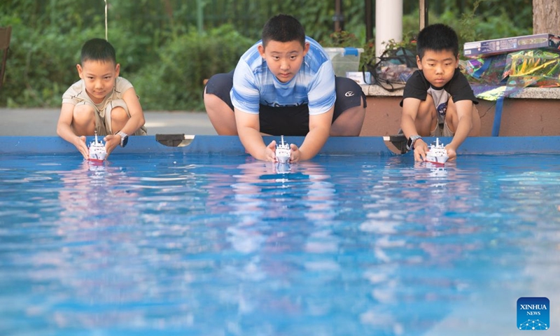 Children place model boats into a pool at a youth palace in Harbin, northeast China's Heilongjiang Province, July 17, 2026. (Photo by Zhang Chunlei/Xinhua)