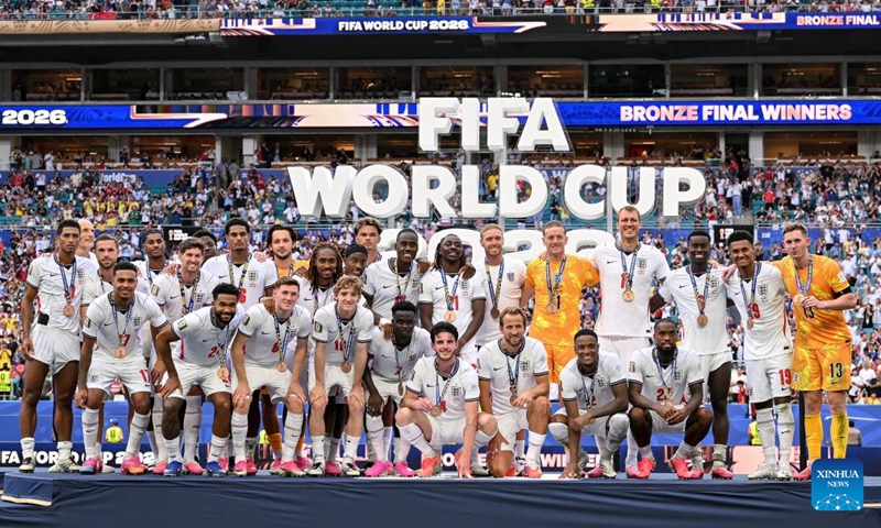 Players of England pose for photos on the podium after winning the bronze final match between France and England at the 2026 FIFA World Cup in Miami, the United States, July 18, 2026. (Xinhua/Chen Yichen)