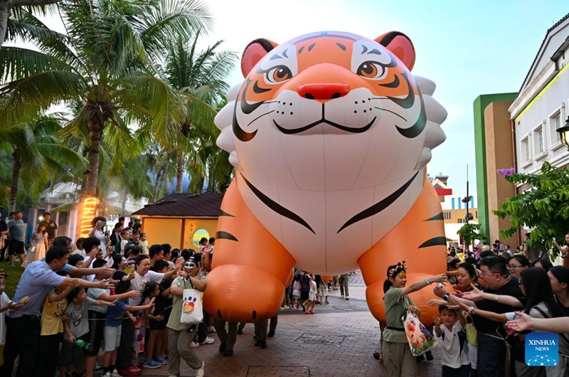Performers interact with audiences during a carnival parade in Haikou, south China's Hainan Province, July 18, 2026. The 2026 Hainan Island Carnival opened here on Saturday and will last until Aug. 18, during which over 50 special events will be held. (Xinhua/Guo Cheng)