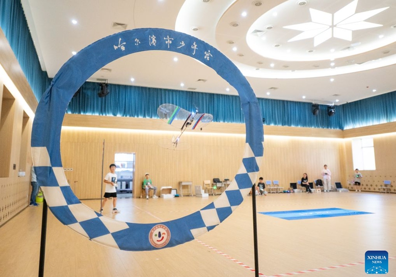 A child operates an aircraft model at a youth palace in Harbin, northeast China's Heilongjiang Province, July 17, 2026. (Photo by Zhang Chunlei/Xinhua)