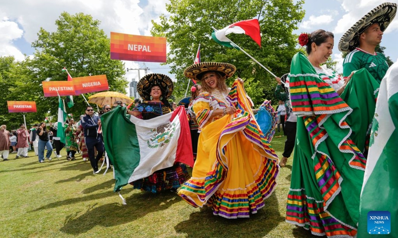Participants in traditional costumes march during the Parade of Cultures at the Fusion Festival in Surrey, British Columbia, Canada, July 18, 2026. The two-day festival, which opened here on Saturday, featured over 50 cultural pavilions offering food, music, dance, and cultural performances from around the world. (Photo by Liang Sen/Xinhua)