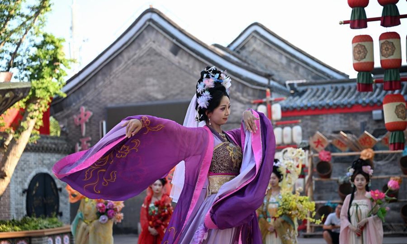 A performer dances at the Hetou Old Street scenic area in Fengnan District, Tangshan, north China's Hebei Province, July 15, 2026. (Xinhua/Mu Yu)