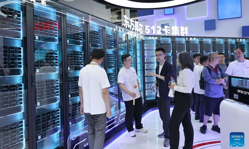 People view a high-performance AI chip cluster displayed during the 2026 World AI Conference and High-Level Meeting on Global AI Governance in Shanghai, east China, July 17, 2026. The 2026 World AI Conference (WAIC) and High-Level Meeting on Global AI Governance opened here on Friday. A group of domestic supernode products draw public attentions during the event. (Xinhua/Fang Zhe)