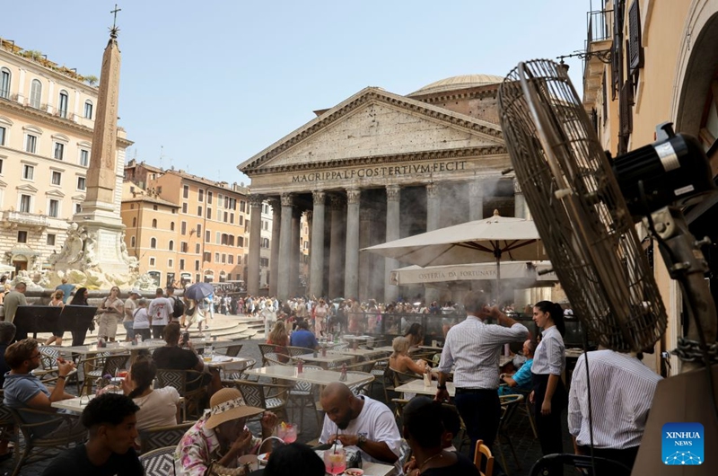 Tourists take a rest under a misting fan near the Pantheon in Rome, Italy, July 19, 2026. A new heatwave is sweeping Italy, with many major cities, including the capital Rome, under red heat alerts. The scorching conditions are forecast to last until next week. Photo: Xinhua