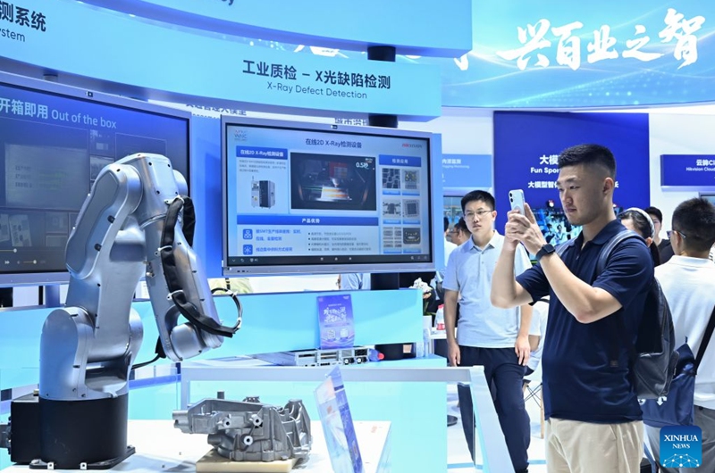 A visitor takes photos of a robot during the 2026 World AI Conference and High-Level Meeting on Global AI Governance in Shanghai, east China, July 19, 2026. The event scheduled from Friday to Monday showcases exhibitions of a number of AI agent hardware and system products, highlighting the transition of next-generation AI from a tool to an intelligent partner, empowering various industries and everyday life. (Xinhua/Chen Haoming)