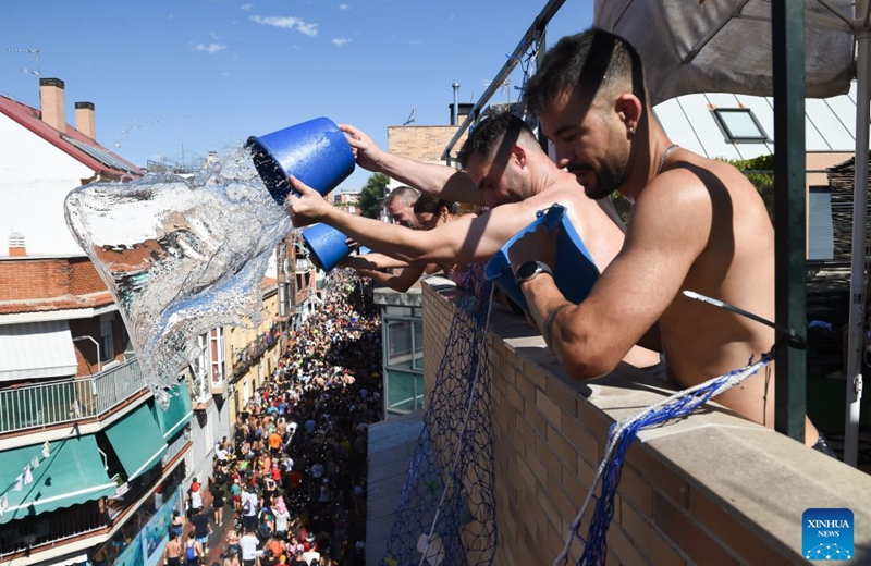 People participate in the Batalla Naval de Vallecas, a water fight festival, in Madrid, Spain, on July 19, 2026. (Photo by Gustavo Valiente/Xinhua)