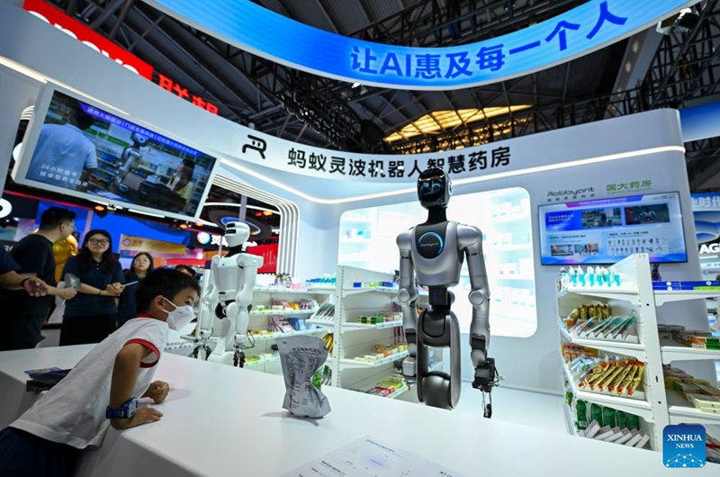 A visitor watches an intelligent robot pharmacy during the 2026 World AI Conference and High-Level Meeting on Global AI Governance in Shanghai, east China, July 19, 2026. The event scheduled from Friday to Monday showcases exhibitions of a number of AI agent hardware and system products, highlighting the transition of next-generation AI from a tool to an intelligent partner, empowering various industries and everyday life. (Xinhua/Chen Haoming)