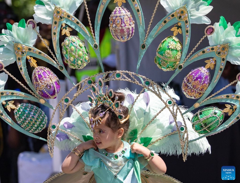 A dressed-up girl is seen during the Junior Carnival Parade of the 2026 Toronto Caribbean Carnival in Toronto, Canada, on July 19, 2026. Thousands of young participants in vivid costumes took part in the parade, celebrating Caribbean culture through music and dance. (Photo by Zou Zheng/Xinhua)
