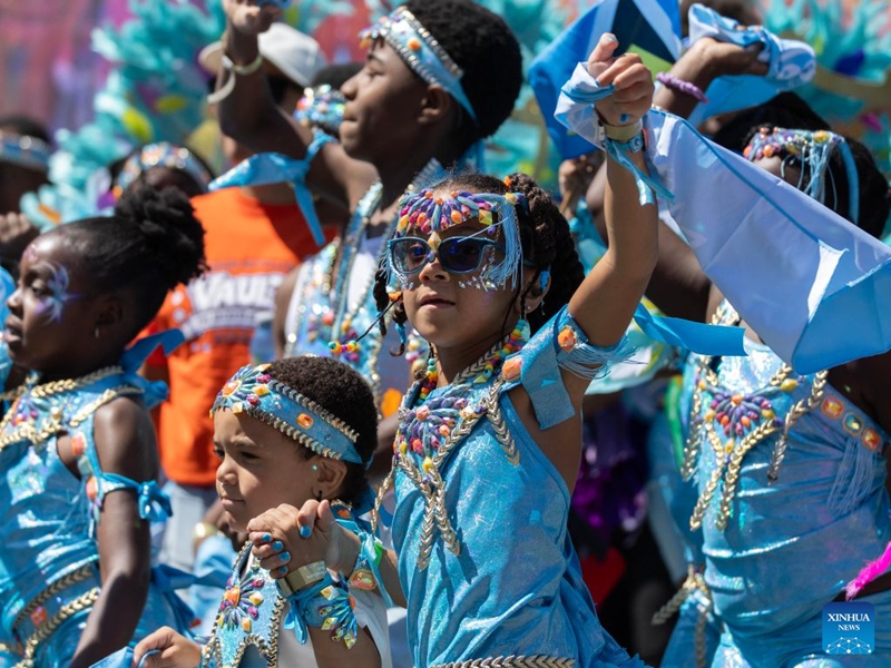 Dressed-up children are seen during the Junior Carnival Parade of the 2026 Toronto Caribbean Carnival in Toronto, Canada, on July 19, 2026. Thousands of young participants in vivid costumes took part in the parade, celebrating Caribbean culture through music and dance. (Photo by Zou Zheng/Xinhua)