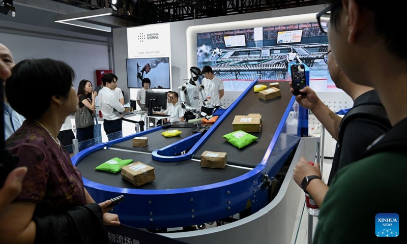 A robot sorts out packages during the 2026 World AI Conference in Shanghai, east China, July 19, 2026. The ongoing 2026 World AI Conference turns out to be a highly competitive arena for general embodied AI products from more than 200 providers. It refers to a general-purpose intelligence system that enables robots to perform variable tasks and adapt to different application scenarios. (Xinhua/Huang Xiaoyong)