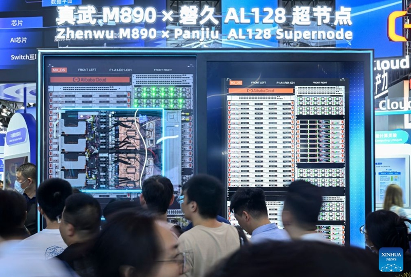 People visit the Zhenwu M890 x Panjiu AL128 supernode displayed during the 2026 World AI Conference and High-Level Meeting on Global AI Governance in Shanghai, east China, July 19, 2026. The 2026 World AI Conference (WAIC) and High-Level Meeting on Global AI Governance opened here on Friday. A group of domestic supernode products draw public attentions during the event. (Xinhua/Chen Haoming)