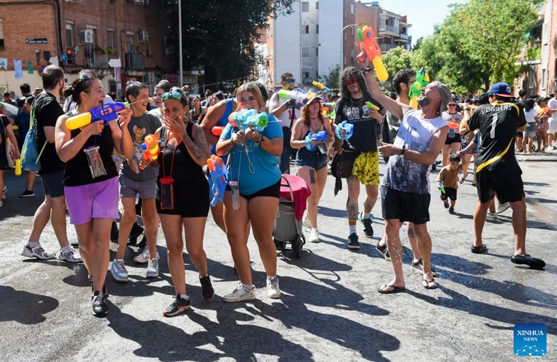 People participate in the Batalla Naval de Vallecas, a water fight festival, in Madrid, Spain, on July 19, 2026. (Photo by Gustavo Valiente/Xinhua)