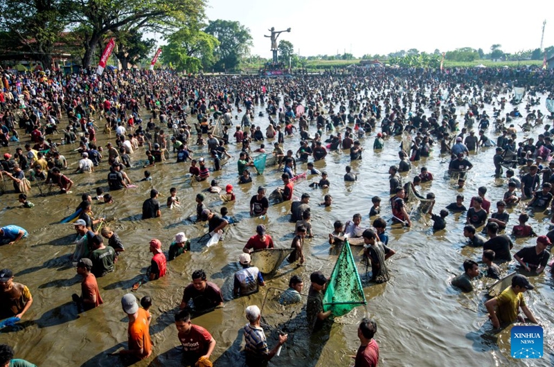 People attend Festival Memet Ikan, or fish catching festival, at Gemblegan village in Klaten regency, Central Java, Indonesia, July 19, 2026. (Photo by Agung Supriyanto/Xinhua)