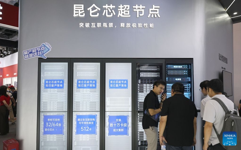 People discuss in front of the supernode products of Kunlunxin displayed during the 2026 World AI Conference and High-Level Meeting on Global AI Governance in Shanghai, east China, July 17, 2026. The 2026 World AI Conference (WAIC) and High-Level Meeting on Global AI Governance opened here on Friday. A group of domestic supernode products draw public attentions during the event. (Xinhua/Fang Zhe)