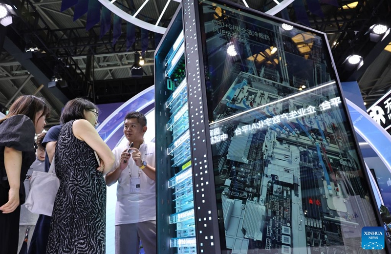 A staff member introduces the supernode server CRS6000S to visitors during the 2026 World AI Conference and High-Level Meeting on Global AI Governance in Shanghai, east China, July 19, 2026. The 2026 World AI Conference (WAIC) and High-Level Meeting on Global AI Governance opened here on Friday. A group of domestic supernode products draw public attentions during the event. (Xinhua/Fang Zhe)