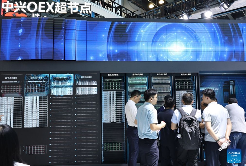People talk in front of the OEX supernode of ZTE displayed during the 2026 World AI Conference and High-Level Meeting on Global AI Governance in Shanghai, east China, July 17, 2026. The 2026 World AI Conference (WAIC) and High-Level Meeting on Global AI Governance opened here on Friday. A group of domestic supernode products draw public attentions during the event. (Xinhua/Fang Zhe)