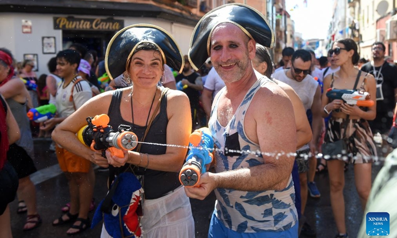 People participate in the Batalla Naval de Vallecas, a water fight festival, in Madrid, Spain, on July 19, 2026. (Photo by Gustavo Valiente/Xinhua)