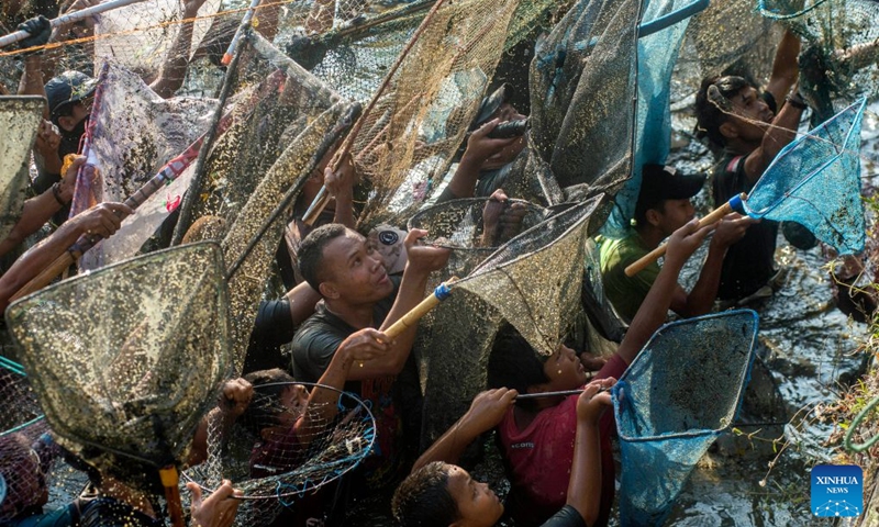 People attend Festival Memet Ikan, or fish catching festival, at Gemblegan village in Klaten regency, Central Java, Indonesia, July 19, 2026. (Photo by Agung Supriyanto/Xinhua)