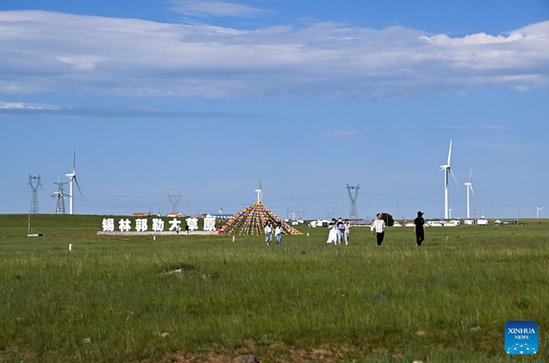 Tourists have fun at the Xilingol grassland in north China's Inner Mongolia Autonomous Region, July 19, 2026. (Xinhua/Li Zhipeng)
