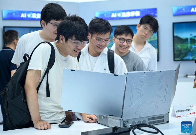 Visitors observe a portable transient 3D modeling AI system during the 2026 World AI Conference and High-Level Meeting on Global AI Governance in Shanghai, east China, July 19, 2026. The event scheduled from Friday to Monday showcases exhibitions of a number of AI agent hardware and system products, highlighting the transition of next-generation AI from a tool to an intelligent partner, empowering various industries and everyday life. (Xinhua/Chen Haoming)