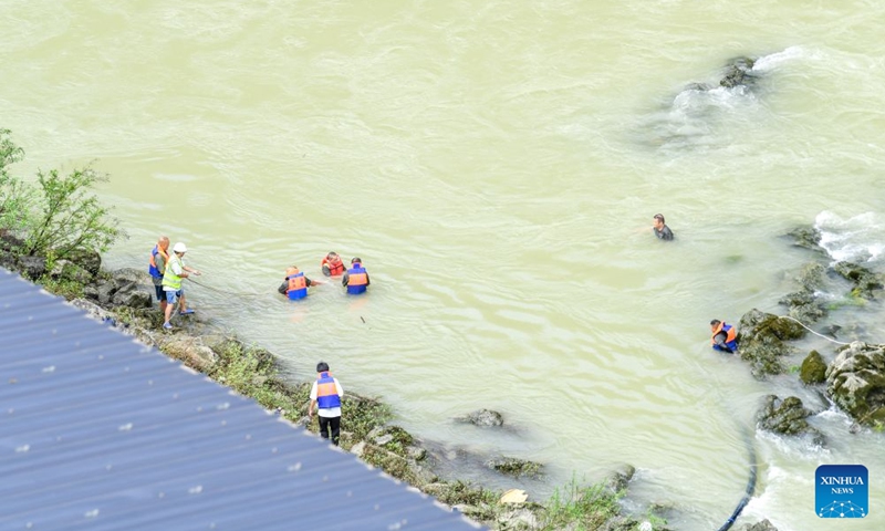 Rescuers work at the site of a mountain collapse in Pengshui Miao and Tujia Autonomous County of Chongqing, southwest China, July 19, 2026. A rainfall-induced mountain collapse occurred at 9:08 a.m. on Friday in the Hanjia sub-district of Pengshui, burying more than 10 residential buildings, while leaving some local residents trapped and unaccounted for.
China activated a Level-II national emergency response for geological disasters. Multiple rescue forces including emergency response, fire control and public security rushed to the scene and launched full-scale search and rescue operations, while local residents also volunteered to take part in the rescue efforts. Photo: Xinhua