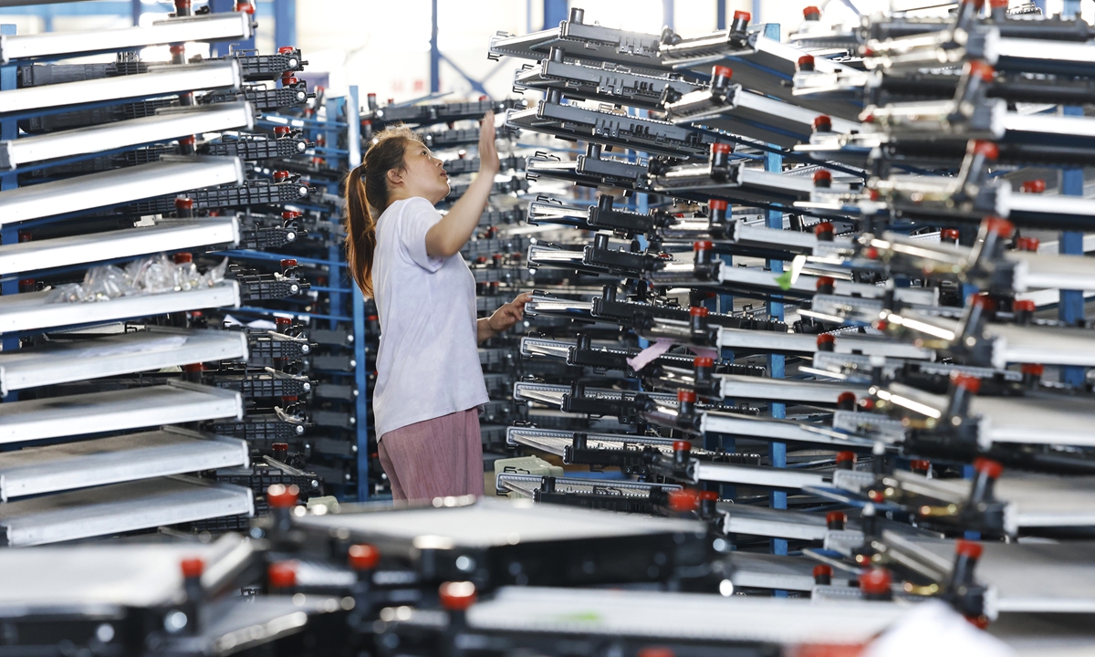 A worker checks condensing system components for export vehicles at the workshop of an auto parts company in Suqian, East China's Jiangsu Province, on July 21, 2026. In 2025, revenue of Jiangsu's automobile manufacturing enterprises above designated size reached 1.38 trillion yuan ($203.74 billion), accounting for 12 percent of the national total and ranking first in the country, according to official data. Photo: VCG