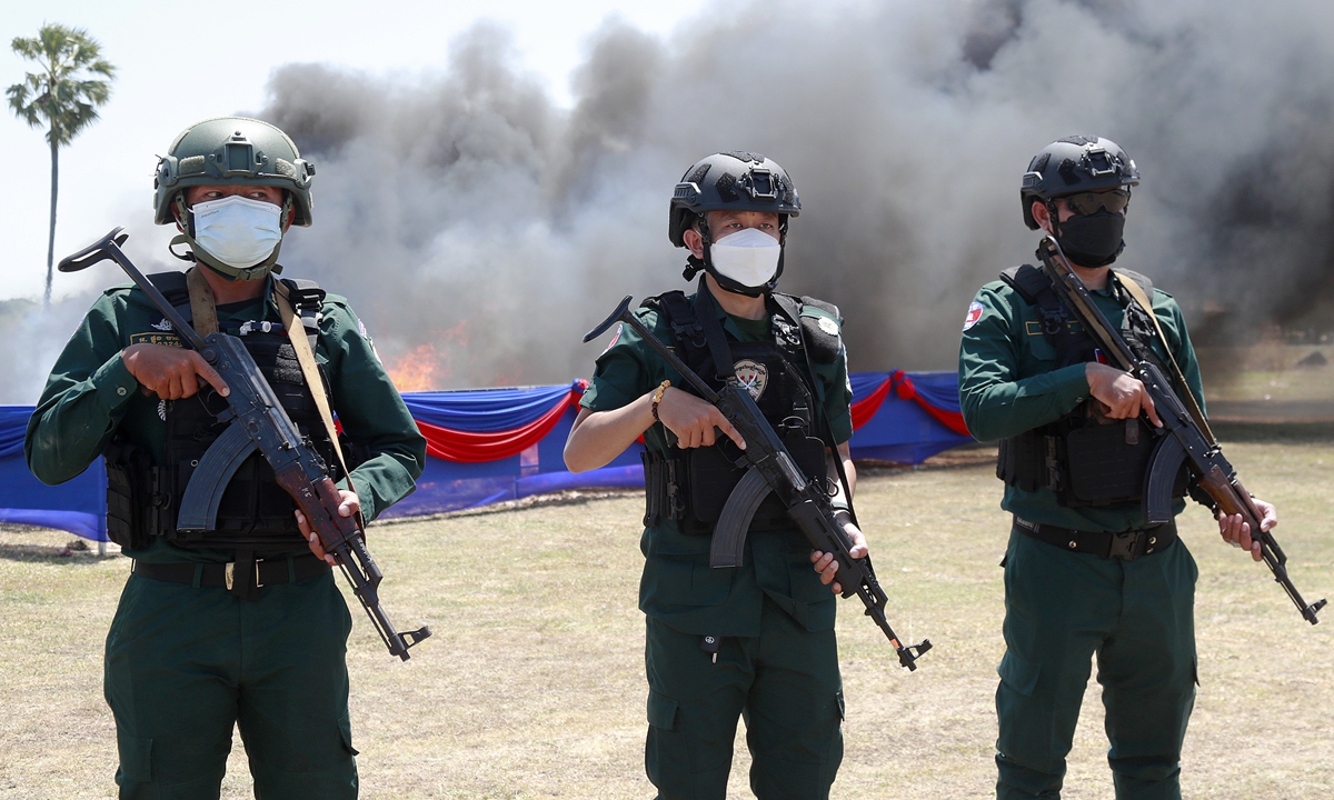 Cambodian police officers stand guard during a drug destruction event in Kandal province, Cambodia, on 21 July, 2026. The Cambodian National Authority for Combating Drugs destroyed nearly five tons of illegal drug substance ingredients in an effort to fight against drug production, distribution and drug trafficking. Photo: VCG