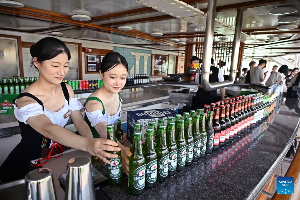 Staff members prepare beer for visitors aboard cruise ship Dream at Qingdao International Cruise Terminal in Qingdao, east China's Shandong Province, July 20, 2026. As a part of the 36th Qingdao International Beer Festival, a cruise tour event kicked off at the Qingdao International Cruise Terminal on Monday. Featuring live performances and interactive experiences, this event created an immersive maritime leisure space for visitors. (Xinhua/Li Ziheng)