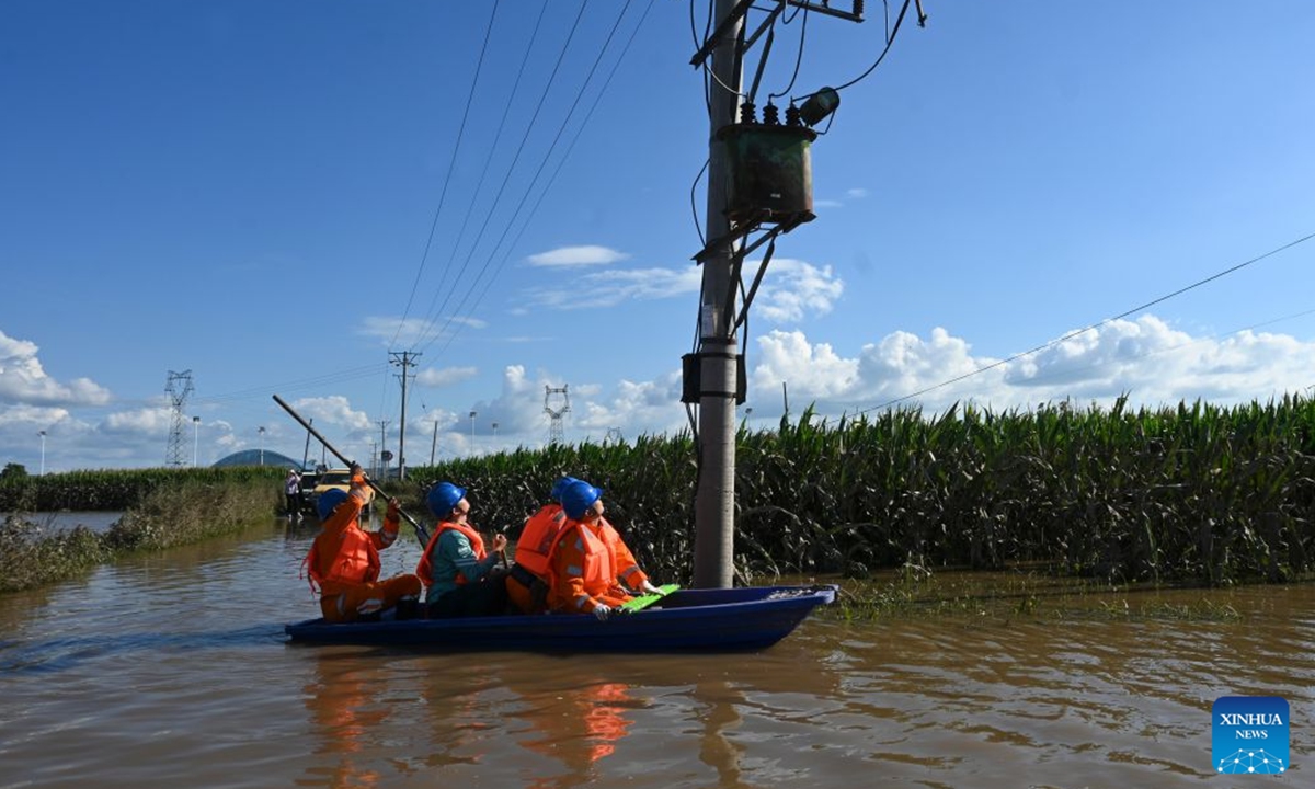 Staff members inspect power lines for electricity restoration in Ning'an Township of Ning'an City, Mudanjiang, northeast China's Heilongjiang Province, July 20, 2026. Water supply and power departments in Mudanjiang have stepped up efforts to restore water and electricity services in the affected areas as flooding gradually recedes in the city. (Photo by Zhang Chunxiang/Xinhua)
