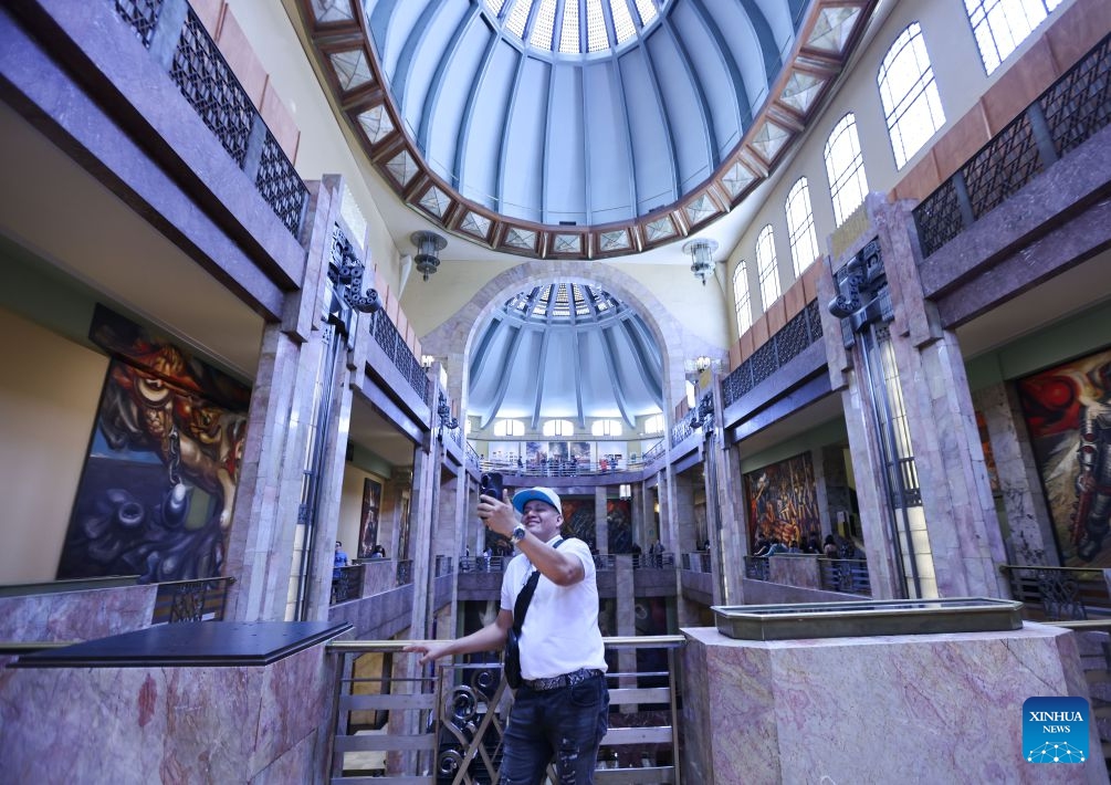A visitor takes selfies at the Museum of Palacio de Bellas Artes, in Mexico City, Mexico, on July 19, 2026. The museum offers free admission on Sundays, attracting large numbers of residents and tourists to explore its exhibitions. (Xinhua/Liu Wenhui)