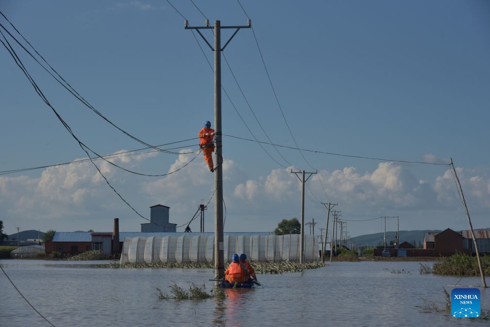 Staff members inspect power lines for electricity restoration in Ning'an Township of Ning'an City, Mudanjiang, northeast China's Heilongjiang Province, July 20, 2026. Water supply and power departments in Mudanjiang have stepped up efforts to restore water and electricity services in the affected areas as flooding gradually recedes in the city. (Photo by Zhang Chunxiang/Xinhua)