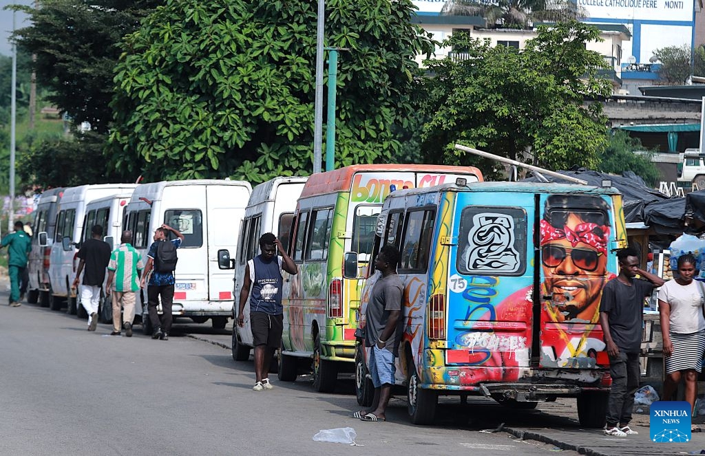 A row of minibuses wait for passengers in Abidjan, Cote d'Ivoire, on July 21, 2026. Colorful minibuses serve as a primary mode of transport and a vibrant element of local street culture in Abidjan, the economic capital of Cote d'Ivoire. (Photo by Yvan Sonh/Xinhua)