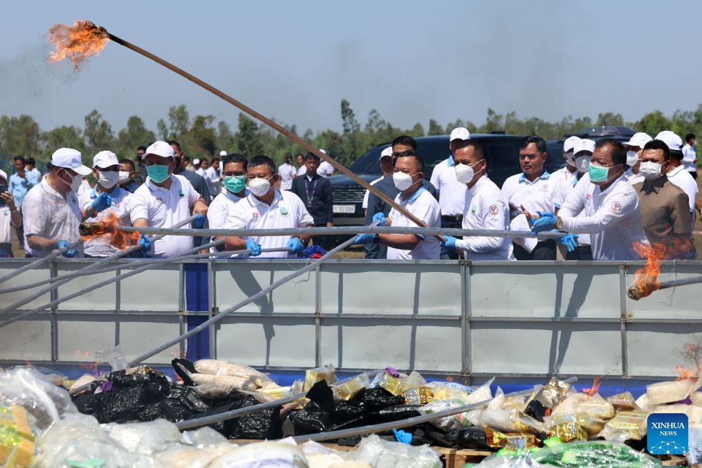 Staff members set illicit drugs on fire during a drug-burning ceremony in Kandal province, Cambodia, July 21, 2026. Cambodia destroyed 5.62 tons of illicit drugs and precursor chemicals valued at 500 million U.S. dollars on Tuesday, Deputy Prime Minister and Interior Minister Sar Sokha said. (Photo by Sovannara/Xinhua)