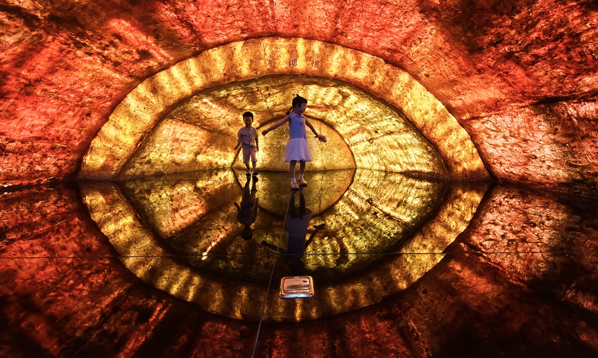 Kids try an immersive display at an exhibition on the Earth's core at the Nanjing Geological Museum in Nanjing, East China's Jiangsu Province, on July 22, 2026. During the summer vacation, numerous parents bring their children to tour exhibition zones covering mineral resources, geology and other themes, immersing themselves in the vast and marvelous mysteries of the planet. Photo: VCG